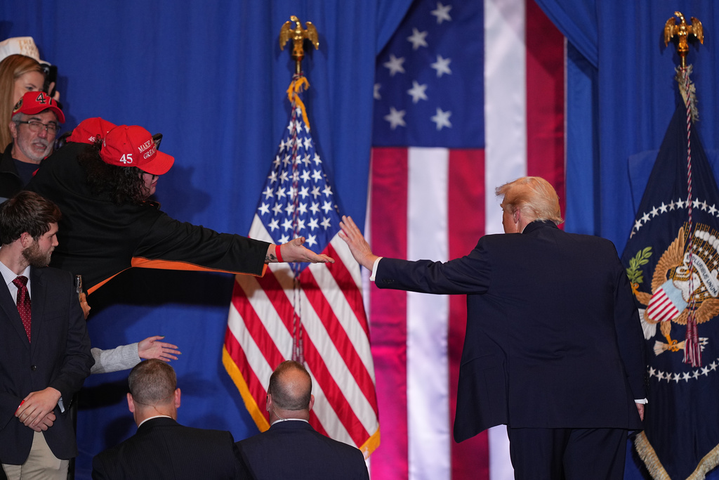 President Donald Trump reaches out to a supporter after speaking at the Mount Airy Casino Resort in Mount Pocono, Pa., Tuesday, Dec. 9, 2025. (AP Photo/Matt Rourke)