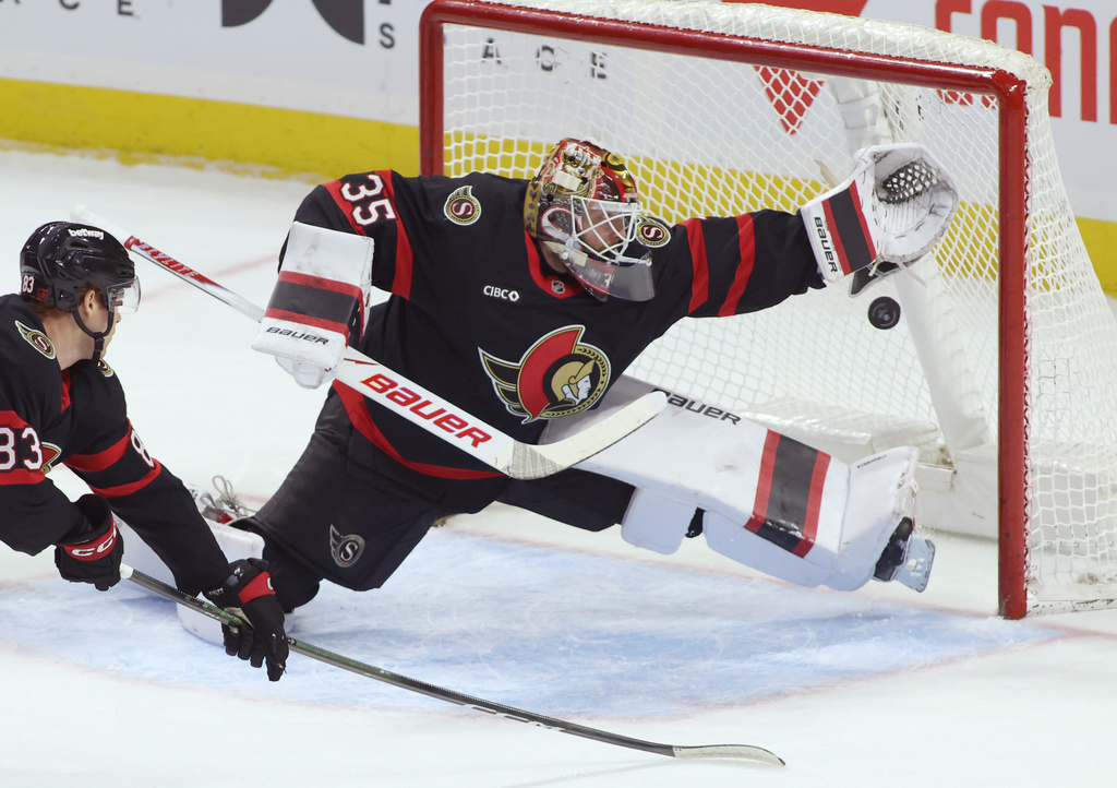 Ottawa Senators goaltender Linus Ullmark (35) reaches for the puck during the first period of an NHL hockey game in Ottawa, Ontario, Thursday, Dec. 18, 2025. (Patrick Doyle/The Canadian Press via AP)