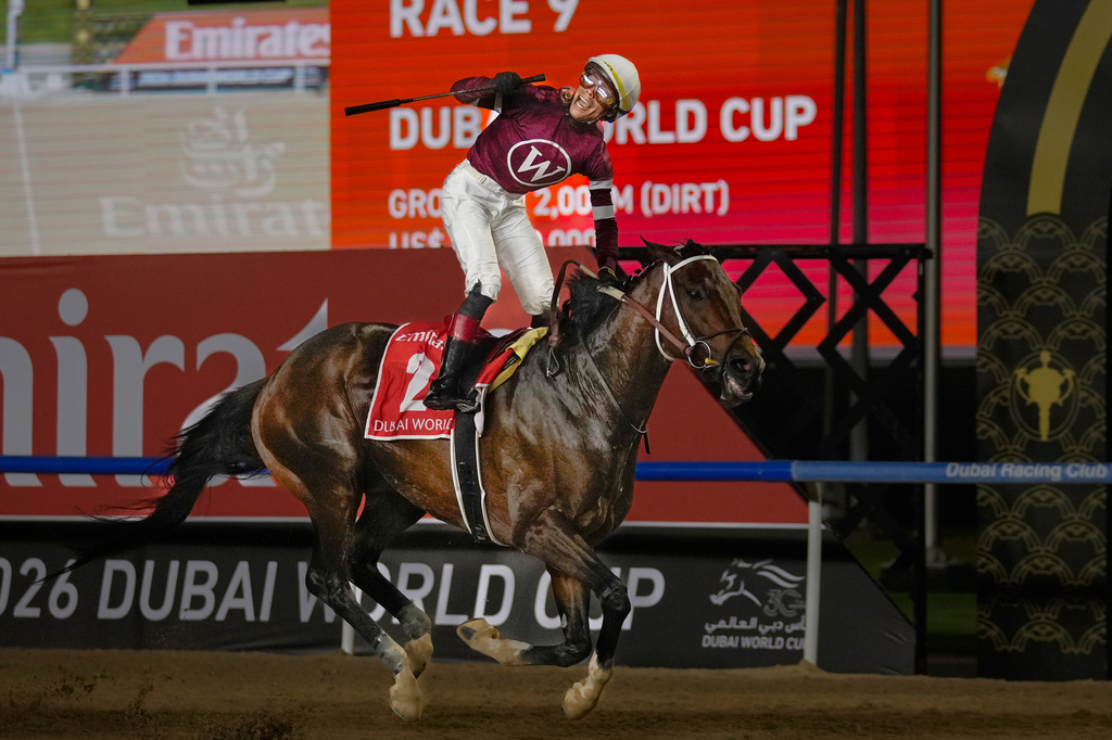 Jockey Jose Ortiz, aboard Magnitude, celebrates winning the $12 million Dubai World Cup horse race over 2000m (10 furlongs) at Meydan Racecourse in Dubai, the United Arab Emirates, Saturday, March 28, 2026. (AP Photo/Altaf Qadri)