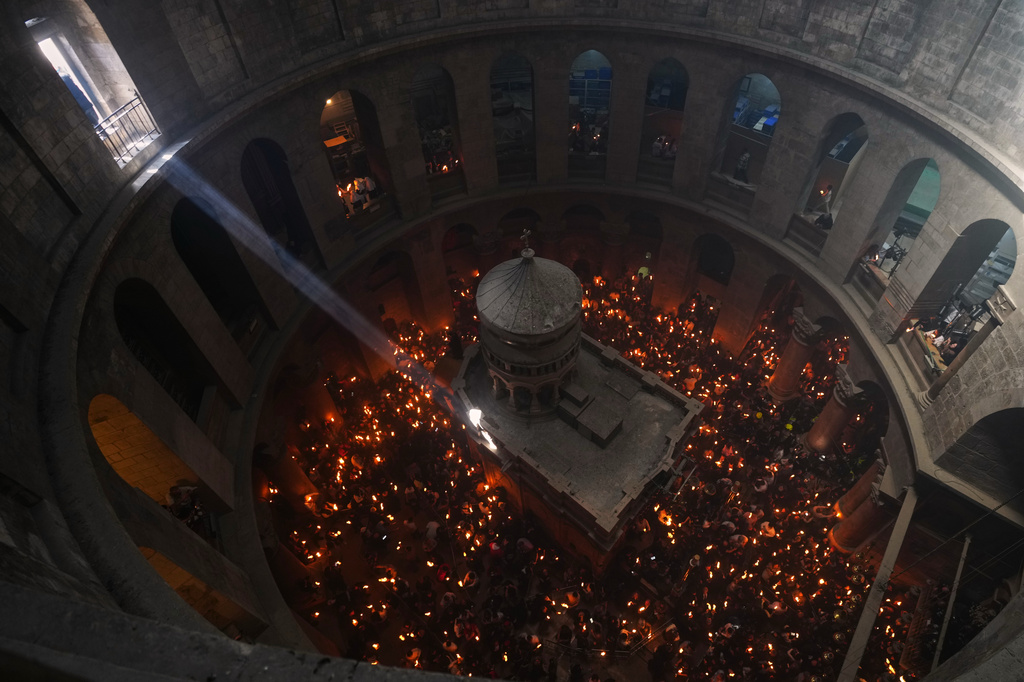 FILE - Christian Orthodox pilgrims hold up candles during the Holy Fire ceremony, at the Church of the Holy Sepulcher in the Old City of Jerusalem, Saturday, April 11, 2026. (AP Photo/Mahmoud Illean, File)