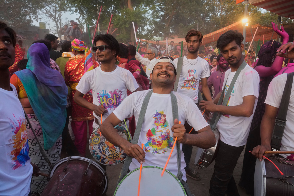 Revelers play drums at the Shri Krishna Janmabhoomi Temple complex during Holi festival celebrations in Mathura, India, on Feb. 27, 2026. (AP Photo/Manish Swarup)