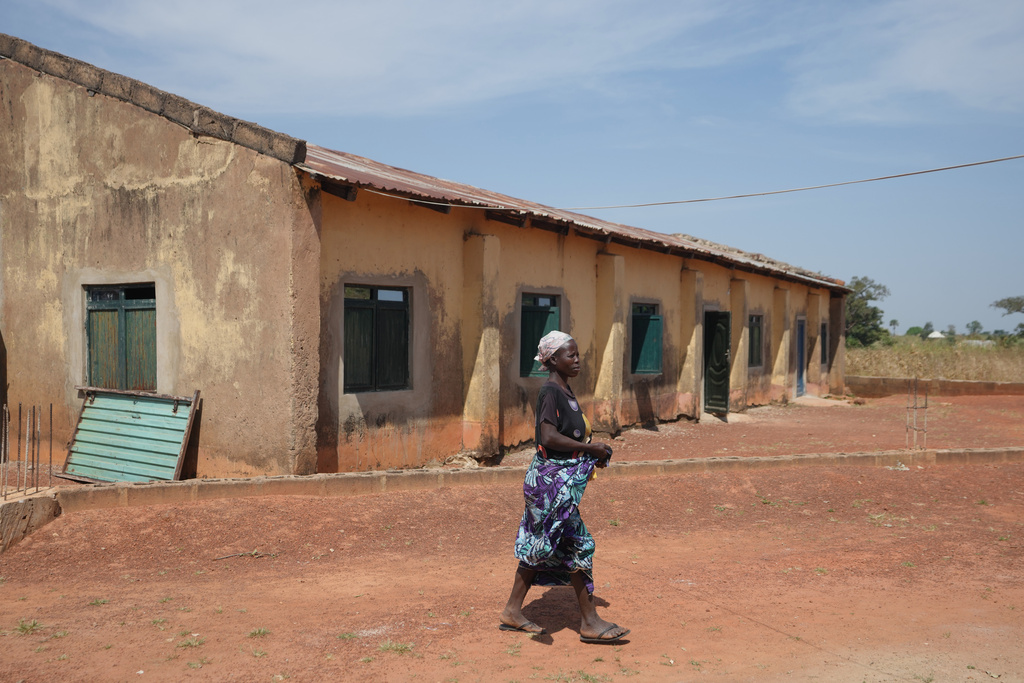 A woman walk past a church were worshipers and their pastor were kidnapped during a church service in Nov. 2024, Kaduna northwestern, Nigeria, Nov. 6, 2025. (AP Photo/Sunday Alamba)