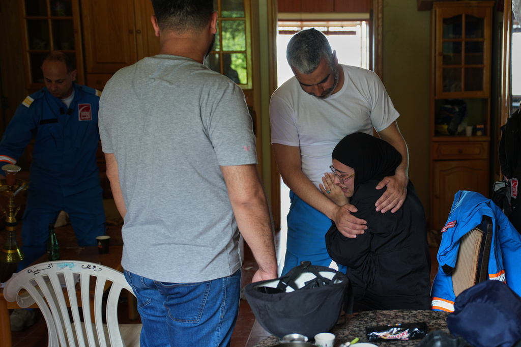 Mohammed Suleiman, chief paramedic of the Nabatiyeh Emergency Services, comforts his niece, Israa Jaber, at the service's temporary center in Nabatiyeh, southern Lebanon, Friday, April 17, 2026. (AP Photo/Hassan Ammar)