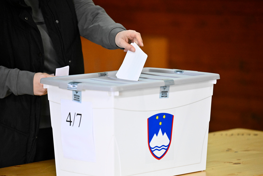 People casts her vote at a polling station for parliamentary elections in Arnace, Slovenia, on Sunday, March 22, 2026. (AP Photo/Denes Erdos)