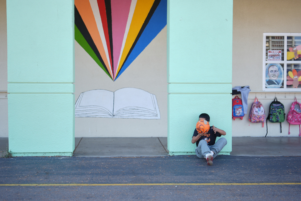 A student takes a break from soccer during recess at Perkins K-8 School Thursday, Nov. 13, 2025, in San Diego. (AP Photo/Gregory Bull)