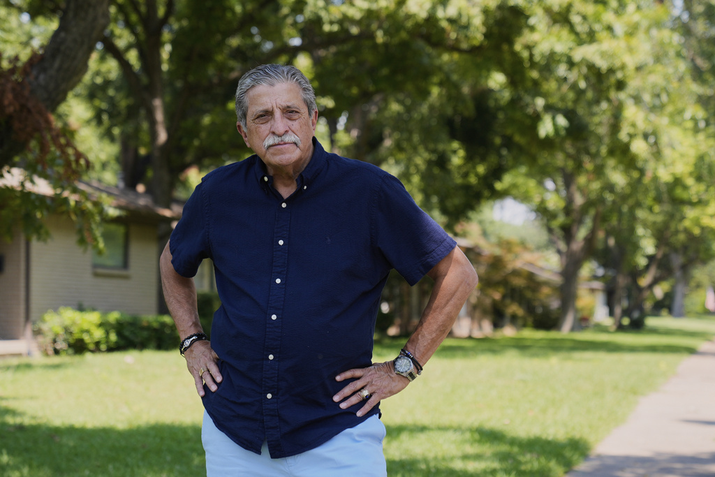 Rene Martinez, president of Dallas LULAC #100, poses for a photo in front of his home Monday, Aug. 25, 2025, in Dallas. (AP Photo/Tony Gutierrez)