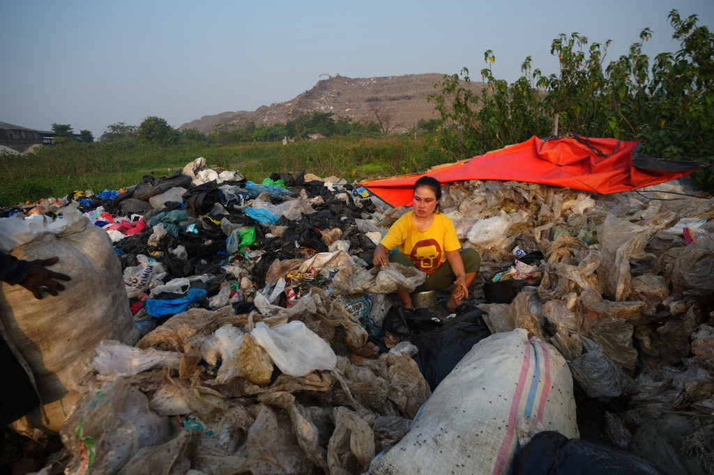 Nur Wencih, a waste picker, sorts recyclable items of her boarding house near the Bantargebang landfill on the outskirts of Jakarta, Indonesia, Monday, July 6, 2026. (AP Photo/Tatan Syuflana)