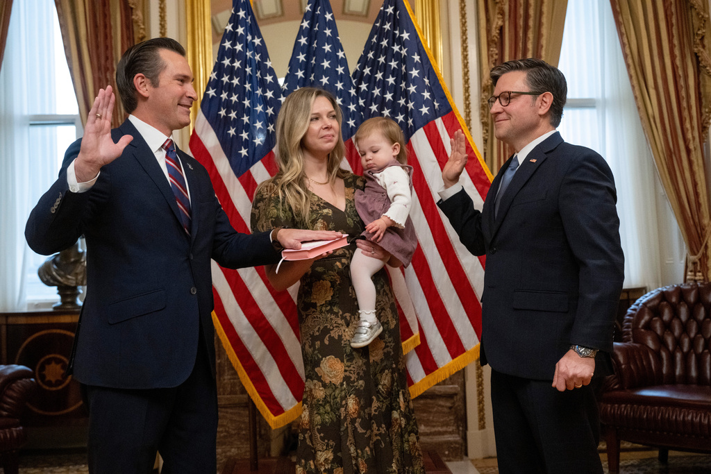 Rep. Matt Van Epps, R-Tenn, left, takes part in a ceremonial swearing-in with Speaker Mike Johnson, R-La., Thursday, Dec. 4, 2025, in Washington. Holding the Bible is Van Epps' wife, Meg Wrather, and their daughter, Amelia Van Epps. (AP Photo/Kevin Wolf)