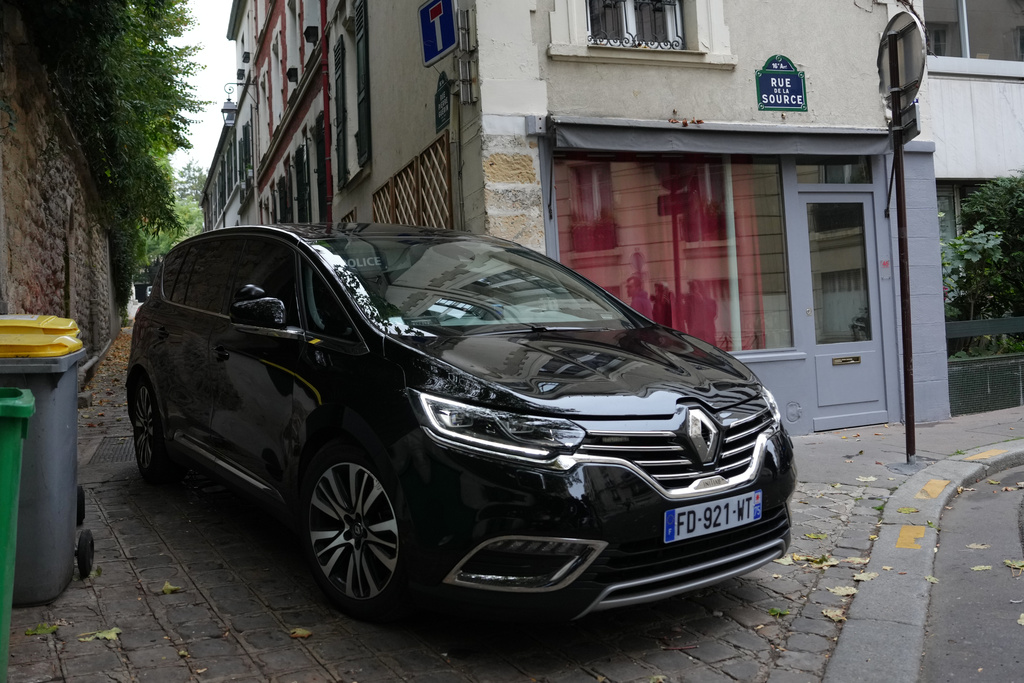 A car carrying former French President Nicolas Sarkozy leaves his home before appearing at the National Financial Prosecutor's office to set a date and location for his incarceration, Monday, Oct. 13, 2025 in Paris. (AP Photo/Aurelien Morissard)