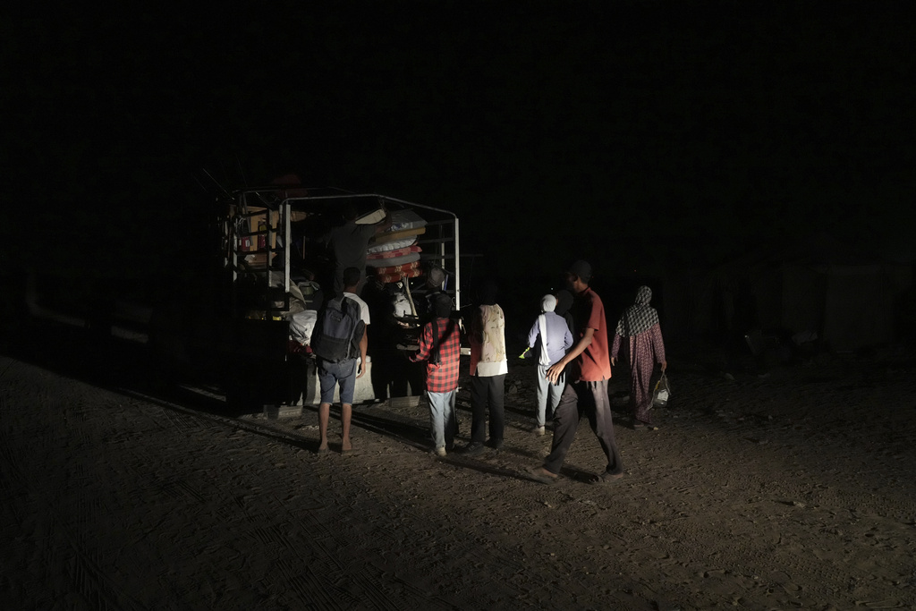 Members of the Abu Jarad family unload their belongings from a truck in Khan Younis, Gaza Strip, Sept. 10, 2025, after fleeing Gaza City following evacuation orders issued by the Israeli army. (AP Photo/Abdel Kareem Hana)