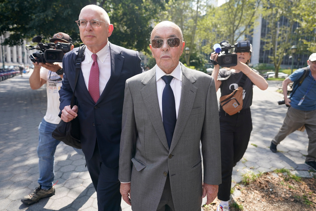 FILE - British billionaire Joe Lewis leaves, center, Manhattan federal court, July 26, 2023, in New York. (AP Photo/Mary Altaffer, File)