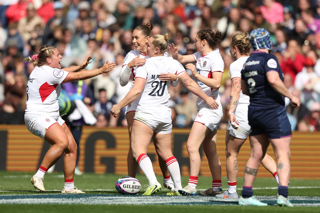 England's Marlie Packer, center, celebrates scoring her side's ninth try of the game, during the Women's Six Nations rugby match between Scotland and England in Edinburgh, Scotland, Saturday April 18, 2026. (Ewan Bootman/PA via AP)