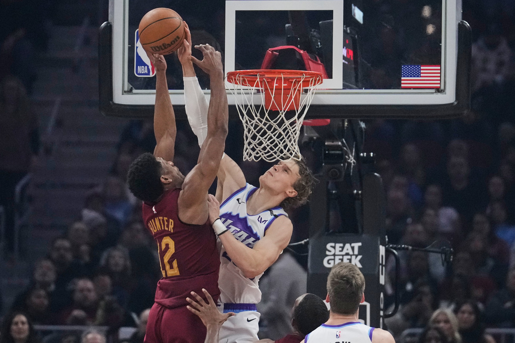 Utah Jazz forward Lauri Markkanen, right, blocks a shot by Cleveland Cavaliers forward De'andre Hunter (12) in the first half of an NBA basketball game in Cleveland, Monday, Jan. 12, 2026. (AP Photo/Sue Ogrocki)