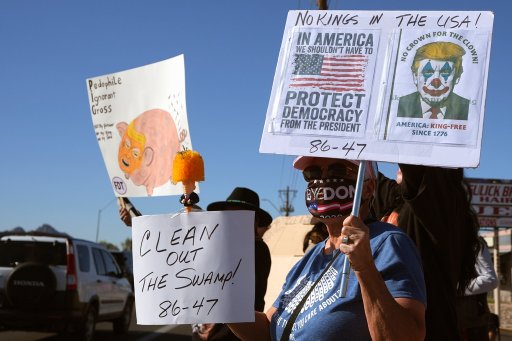 Protesters gather prior to a Turning Point USA event where President Donald Trump is scheduled to speak Friday, April 17, 2026, in Phoenix. (AP Photo/Ross D. Franklin)