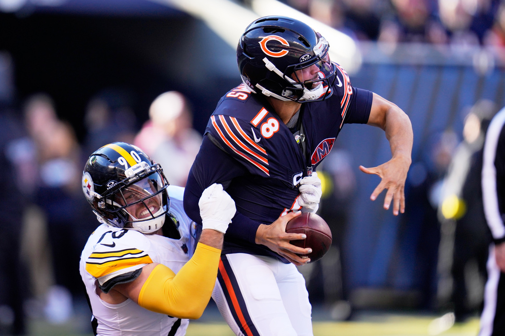 Pittsburgh Steelers linebacker T.J. Watt (90) sacks Chicago Bears quarterback Caleb Williams, forcing a fumble that the Steelers Nick Herbig recovered in the end zone for a touchdown during the first half of an NFL football game Sunday, Nov. 23, 2025, in Chicago. (AP Photo/Erin Hooley)