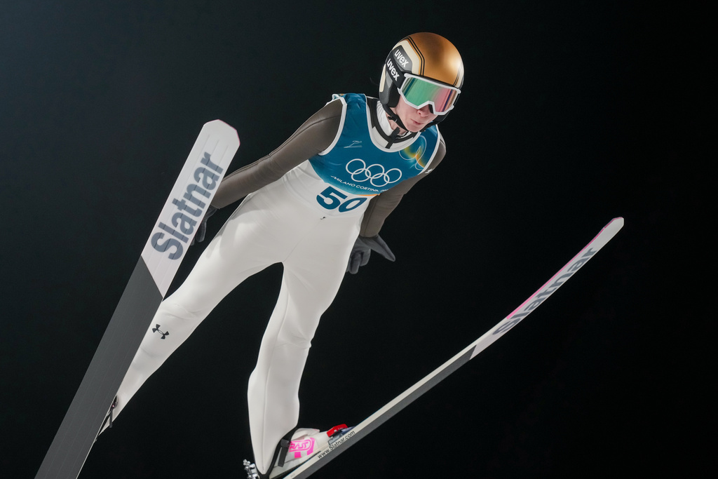 Nika Prevc, of Slovenia, soars through the air during her first round jump of the ski jumping women's large hill individual at the 2026 Winter Olympics, in Predazzo, Italy, Sunday, Feb. 15, 2026. (AP Photo/Evgeniy Maloletka)