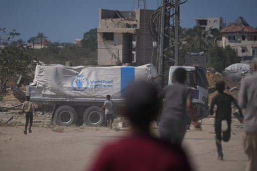 Palestinians rush toward trucks carrying aid from the World Food Programme (WFP) as they drive through Deir al-Balah in central Gaza, Wednesday, Oct. 15, 2025. (AP Photo/Abdel Kareem Hana) Palestinians rush toward trucks carrying aid from the World Food Programme (WFP) as they drive through Deir al-Balah in central Gaza, Wednesday, Oct. 15, 2025. (AP Photo/Abdel Kareem Hana)