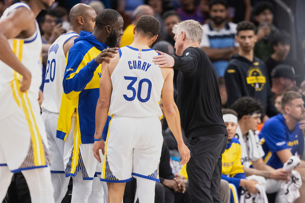 Golden State Warriors forward Draymond Green (23), guard Stephen Curry (30) and head coach Steve Kerr are seen together in closing minutes of their NBA play-in tournament game against the Phoenix Suns at Mortgage Matchup Center in Phoenix, Ariz., Friday, April 17, 2026. (Stephen Lam/San Francisco Chronicle via AP)