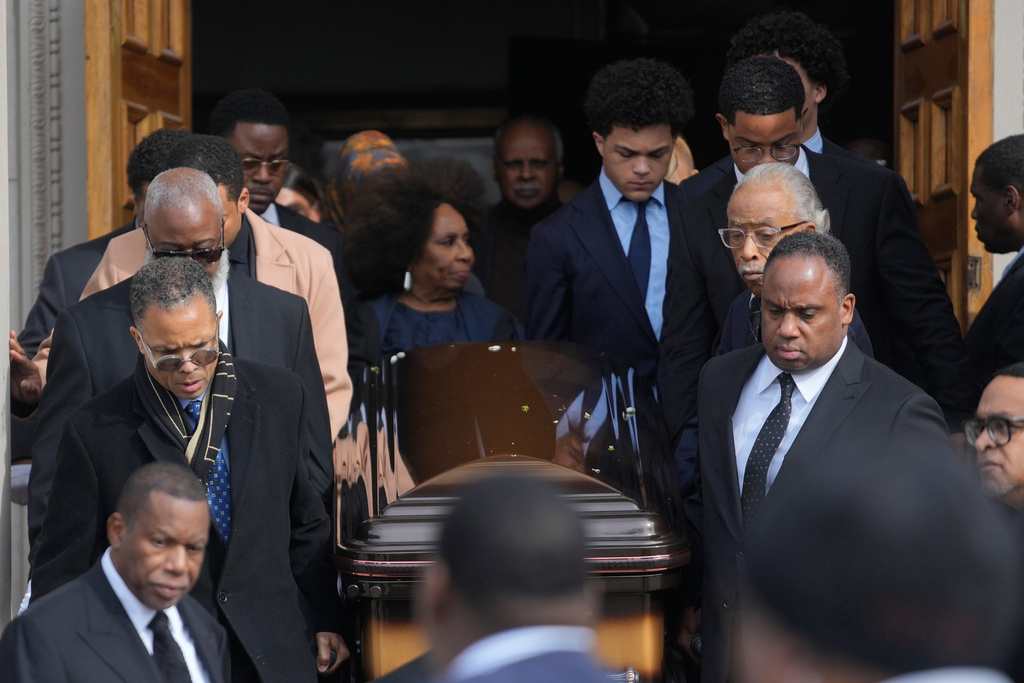 The Jackson family walks along the casket after the Homegoing Celebration of Life for the Rev. Jesse Jackson, Saturday, March 7, 2026, at Rainbow PUSH Coalition headquarters in Chicago. (AP Photo/Erin Hooley)