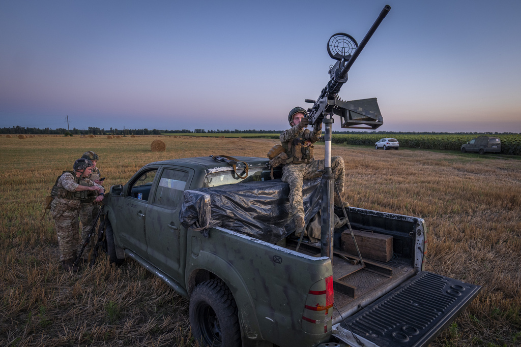 Ukrainian servicemen of the 15th Army Corps stand by an armed pickup truck during night duty in the Chernihiv region, Ukraine, late Tuesday, Aug. 12, 2025. (AP Photo/Dan Bashakov)