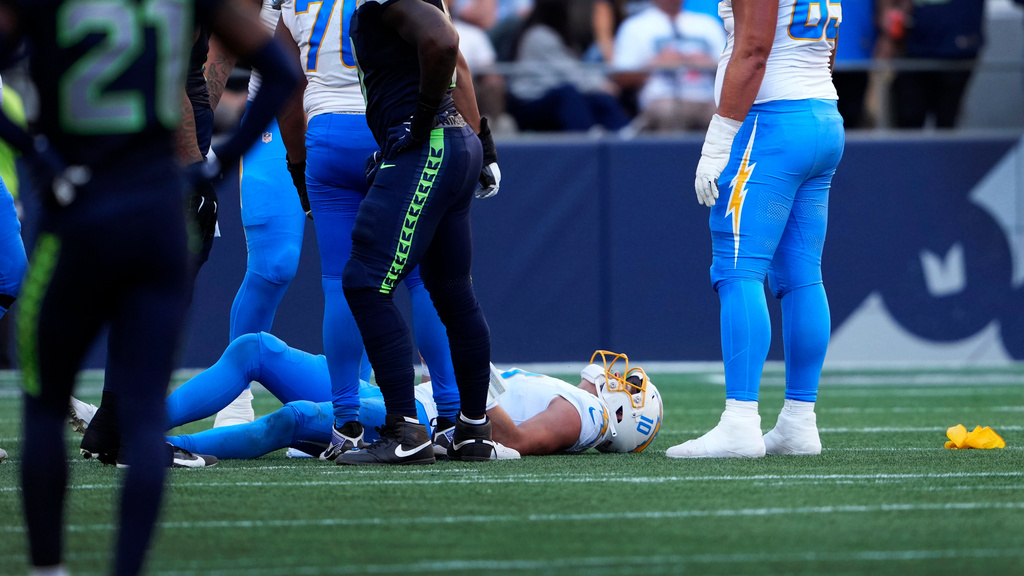 Los Angeles Chargers quarterback Justin Herbert (10) lies on the ground after getting tackled during the second half of an NFL football game against the Seattle Seahawks, Sunday, Oct. 4, 2026, in Seattle. (AP Photo/Lindsey Wasson)