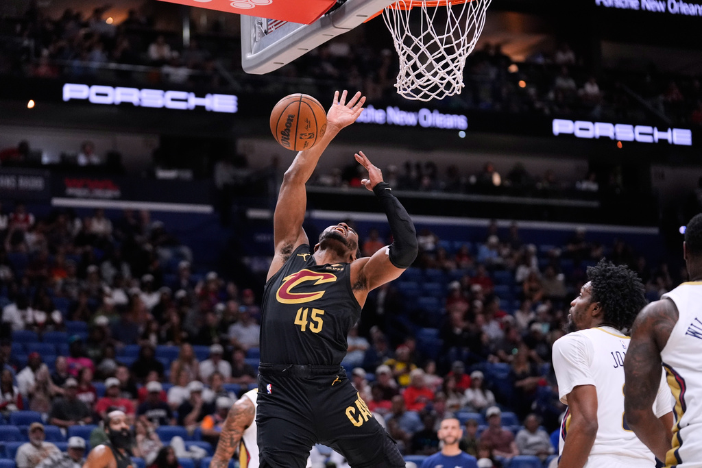Cleveland Cavaliers guard Donovan Mitchell (45) loses the ball as he is fouled while driving to the basket against the New Orleans Pelicans in the first half of an NBA basketball game, Saturday, March 21, 2026, in New Orleans. (AP Photo/Gerald Herbert)