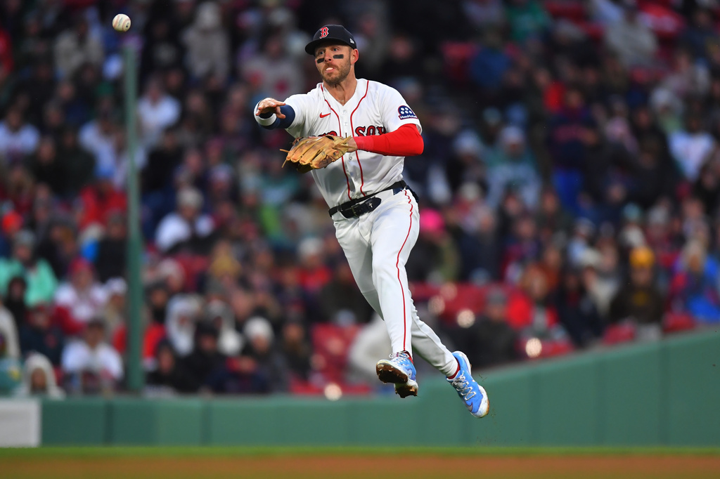 Boston Red Sox shortstop Trevor Story throws to first base to retire San Diego Padres' Ty France in the eighth inning of a baseball game, Saturday, April 4, 2026, in Boston. (AP Photo/Steven Senne)