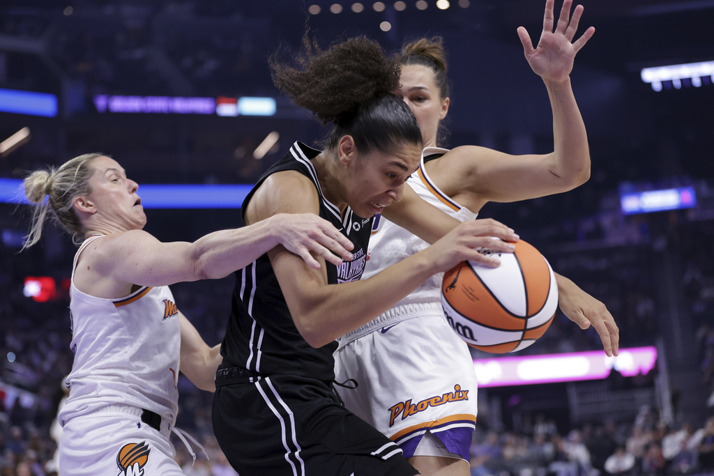 Golden State Valkyries' Janelle Salaun, center, dribbles past Phoenix Mercury's Sami Whitcomb, left, and Kathryn Westbeld during the first half of a WNBA basketball game in San Francisco on Tuesday, Aug. 19, 2025. (Scott Strazzante/San Francisco Chronicle via AP)
