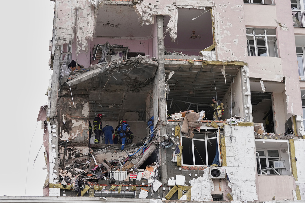 Rescuers work on the scene of a building damaged by a Russian attack in Kyiv, Ukraine, Saturday, Dec. 27, 2025. (AP Photo/Efrem Lukatsky)