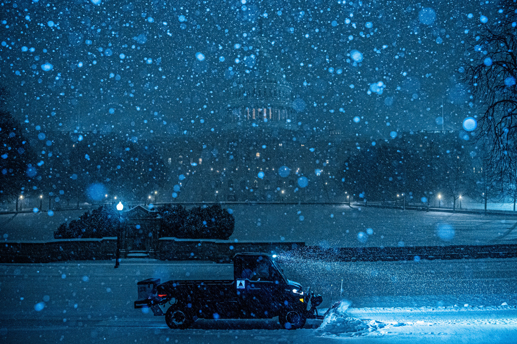 A plow clears snow in front of the U.S. Capitol, Sunday, Jan. 25, 2026, in Washington. (AP Photo/Julia Demaree Nikhinson)