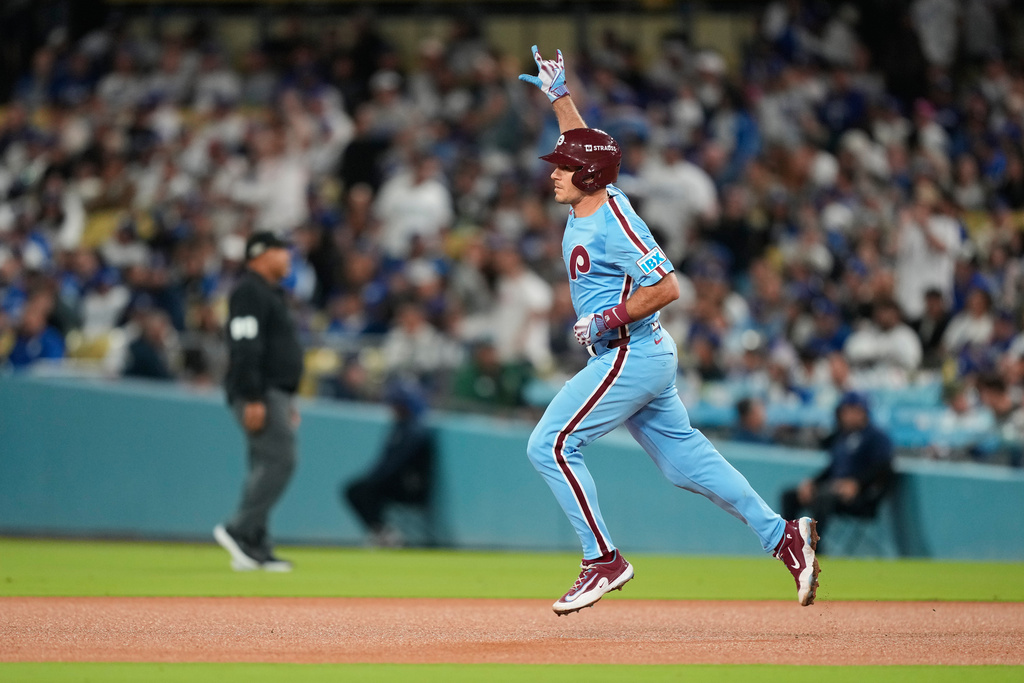 Philadelphia Phillies' J.T. Realmuto celebrates his solo home run as he rounds the bases during the eighth inning in Game 3 of baseball's National League Division Series against the Los Angeles Dodgers, Wednesday, Oct. 8, 2025, in Los Angeles. (AP Photo/Mark J. Terrill)