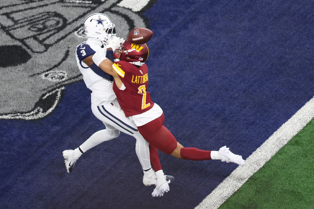 Washington Commanders cornerback Marshon Lattimore (2) attempts to disrupt a pass intended for Dallas Cowboys wide receiver George Pickens (3) during the first half of an NFL football game Sunday, Oct. 19, 2025, in Arlington, Texas. (AP Photo/Gareth Patterson)