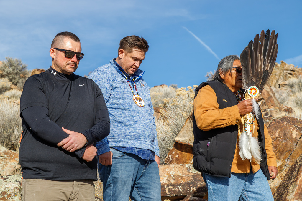 This photo provided by The Church of Jesus Christ of Latter-day Saints shows members of the Northwestern Band of the Shoshone Nation, from left, James Cawley, Brad Parry, Tribal Council Vice-Chair, and Rios Pacheco, the tribe leader, at the site near the Utah-Idaho border, where a rock bearing petroglyphs created by the ancestors of the tribe was returned, Thursday, Dec. 11, 2025. (The Church of Jesus Christ of Latter-day Saints via AP)