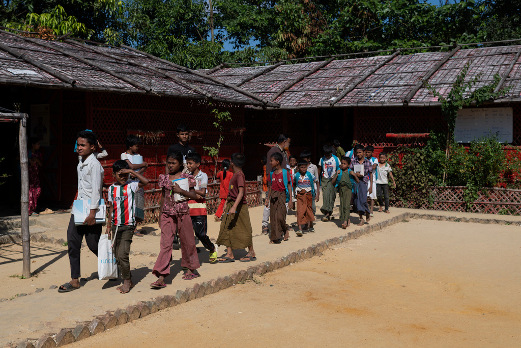 Rohingya refugee children leave their school premises after finishing classes in the Rohingya refugee camp in Cox's Bazar, Bangladesh, Wednesday, Nov. 26, 2025. (AP Photo/Mahmud Hossain Opu)