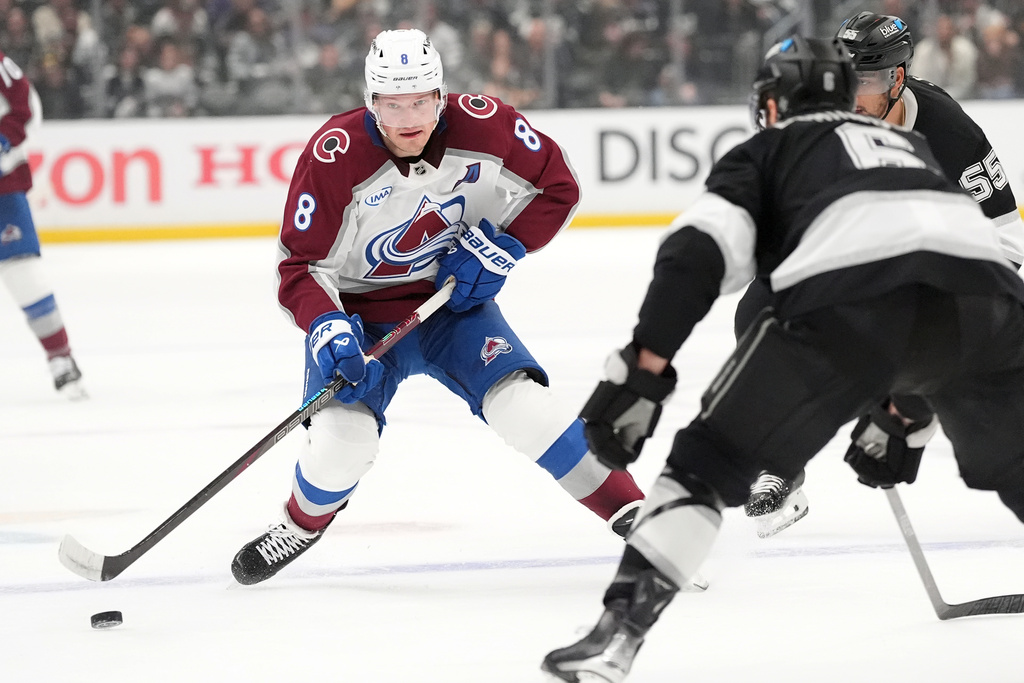 Colorado Avalanche's Cale Makar (8) brings the puck across the blue line against Los Angeles Kings during the first period of Game 4 in the first round of an NHL hockey Stanley Cup playoff series Sunday, April 26, 2026, in Los Angeles. (AP Photo/Scott Strazzante)