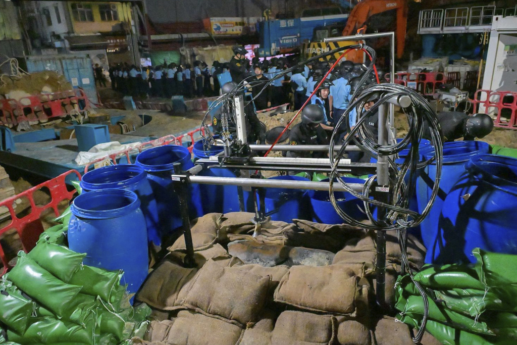 In this photo taken in the early hours of Sept. 20. 2025 and released by Hong Kong Police, police officers prepare to defuse a large U.S.-made bomb left over from World War II that was discovered at a construction site in Hong Kong. (Hong Kong Police via AP)