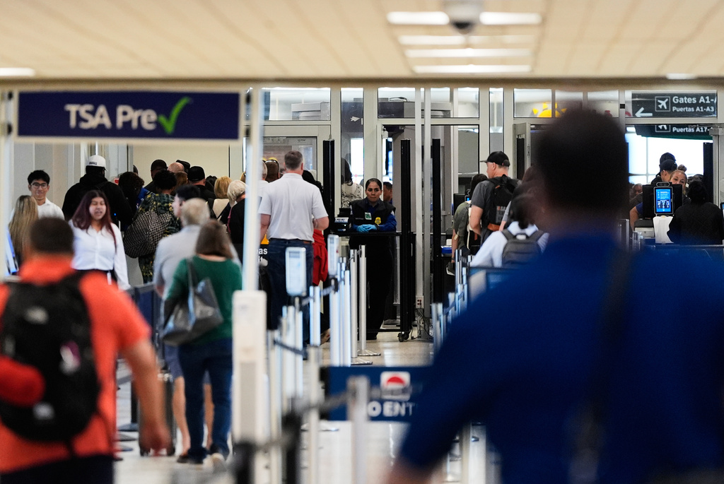 Travelers stand in line at a security checkpoint at George Bush Intercontinental Airport on Friday, Nov. 7, 2025, in Houston. (AP Photo/Ashley Landis)