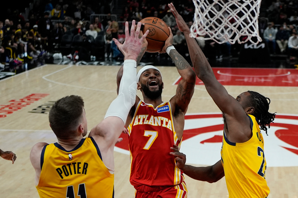 Atlanta Hawks guard Nickeil Alexander-Walker (7) shoots against Indiana Pacers center Micah Potter (11) during the second half of an NBA basketball game, Monday, Jan. 26, 2026, in Atlanta. (AP Photo/Mike Stewart)