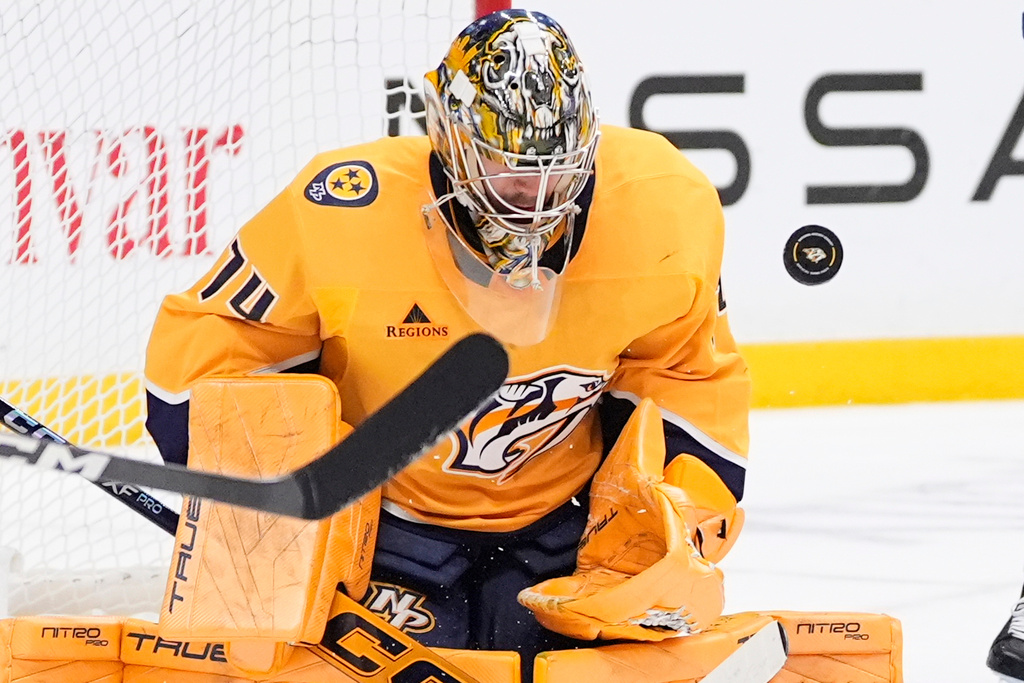 Nashville Predators goaltender Juuse Saros (74) deflects a shot on goal during the third period of an NHL hockey game against the Toronto Maple Leafs, Saturday, Dec. 20, 2025, in Nashville, Tenn. (AP Photo/George Walker IV)