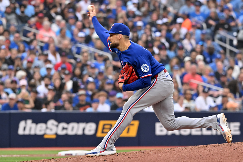 Texas Rangers starting pitcher Nathan Eovaldi (17) throws to a Toronto Blue Jays batter during the first inning of a baseball game in Toronto, Friday June 26, 2026. (Jon Blacker/The Canadian Press via AP)