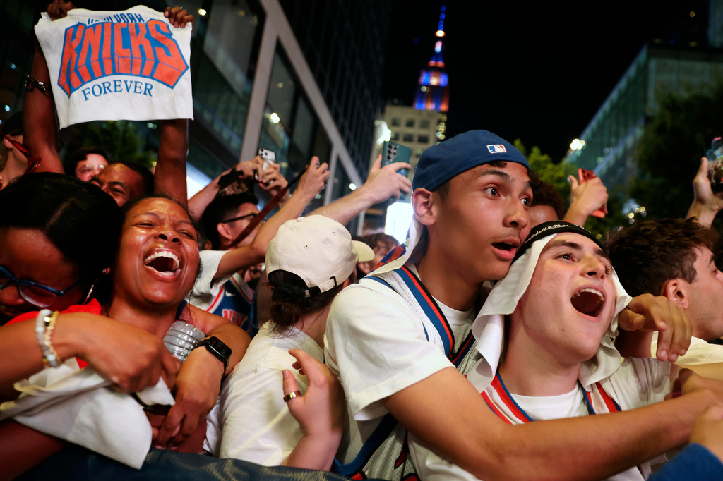 New York Knicks fans celebrate after winning Game 5 of the NBA Finals basketball series against the San Antonio Spurs, Saturday, June 13, 2026, in New York. (AP Photo/Heather Khalifa)