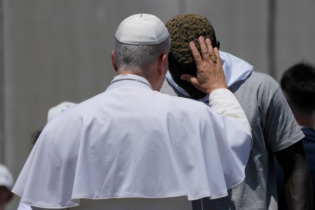 Pope Leo XIV blesses a migrant during a meeting with organisations working with migrants in Arguineguin at the Canary Islands, Spain, Thursday, June 11, 2026. (AP Photo/Alessandra Tarantino)
