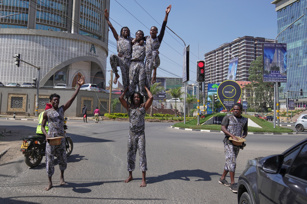 Acrobats perform on a street in Nairobi, Kenya, Wednesday, Aug. 26, 2026. (AP Photo/Brian Inganga)
