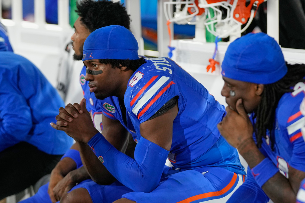 Florida wide receiver J. Michael Sturdivant (9) sits on the bench with teammates as time expires on the clock against Georgia at the end of an NCAA college football game Saturday, Nov. 1, 2025, in Jacksonville, Fla. (AP Photo/John Raoux)