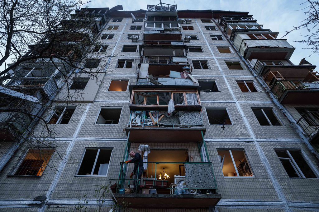 A man clears the rubble inside his house damaged after a Russian strike on residential neighbourhood in Kyiv, Ukraine, on Thursday, April 16, 2026. (AP Photo/Evgeniy Maloletka)
