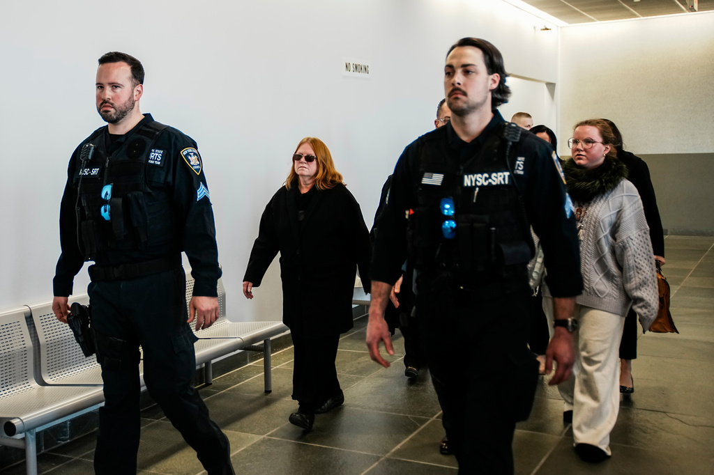 Asa Ellerup, center left, wife, of Rex Heuermann and Victoria Heuermann, right, walk the hallway after departs the courtroom as Rex Heuermann, accused in Long Island's infamous Gilgo Beach serial killings, pleaded guilty on Wednesday, April 8, 2026, at Suffolk County Court in Riverhead, New York. (AP Photo/Eduardo Munoz Alvarez)