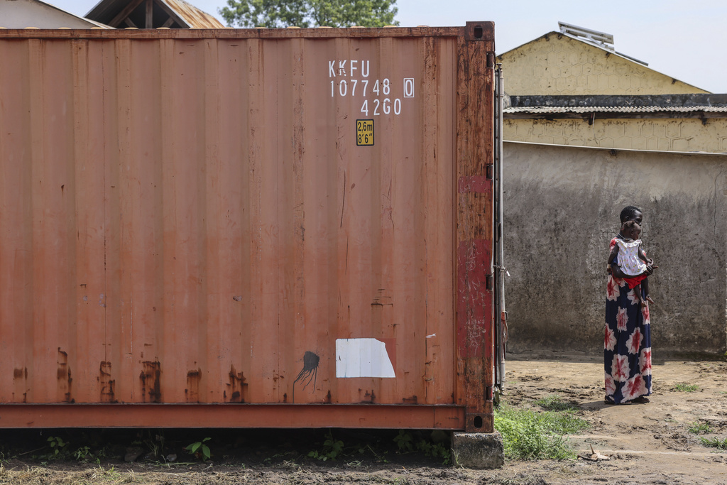 A woman stands with her child inside the compound of Bor State Hospital in Bor, South Sudan, Monday, Aug. 18, 2025. (AP Photo/Caitlin Kelly)