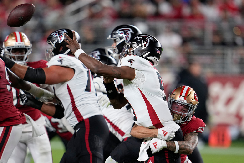 Atlanta Falcons quarterback Michael Penix Jr. (9) passes under pressure from San Francisco 49ers cornerback Chase Lucas (26) in the second half of an NFL football game, Sunday, Oct. 19, 2025, in Santa Clara, Calif. (AP Photo/Godofredo A. Vásquez)