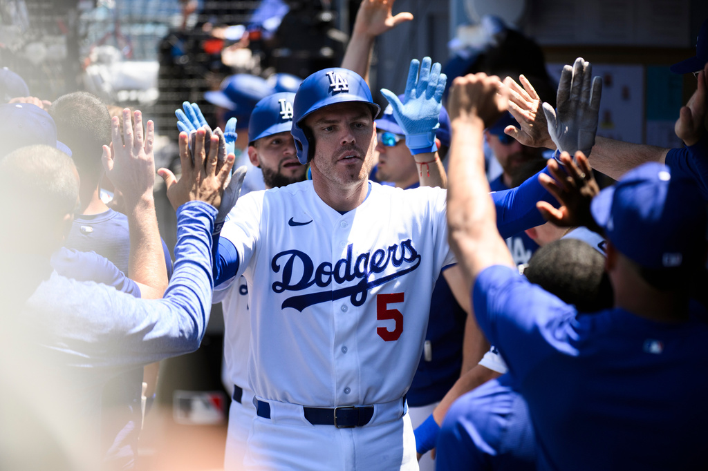 Los Angeles Dodgers' Freddie Freeman celebrates his two-run home run in the dugout during the sixth inning of a baseball game against the Tampa Bay Rays in Los Angeles, Wednesday, June 17, 2026. (AP Photo/Kyusung Gong)