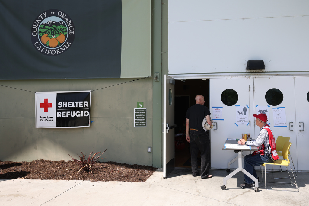People arrive at Freedom Hall, an evacuation center in Fountain Valley, Calif., after a storage tank containing a chemical used to make plastic parts overheated Thursday at an aerospace plastics facility in Garden Grove, on Saturday, May 23, 2026. (AP Photo/Jill Connelly)